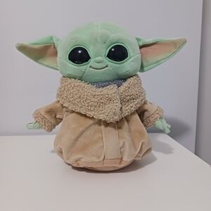 Grogu plush, also known as "Baby Yoda," a character from the Star Wars series.